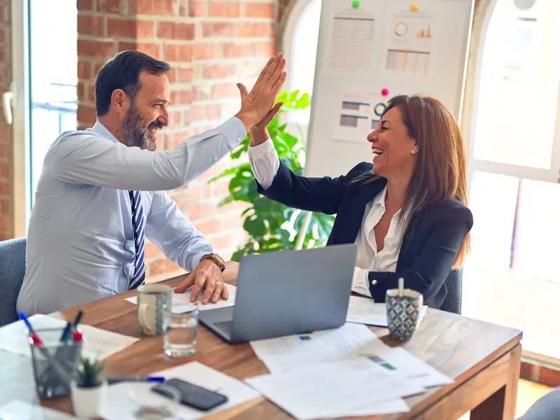 Business man and woman high fives